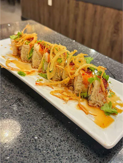 Crispy-topped sushi roll with tempura strips and cilantro at Kinzakaya Japanese Resturant, a Japanese restaurant in West Covina